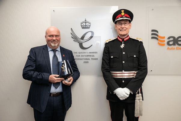 Ed Anderson, Lord Lieutenant of West Yorkshire standing in front of The Queen’s Award office plaque with James Fawkes, Chairman of AES Ltd.